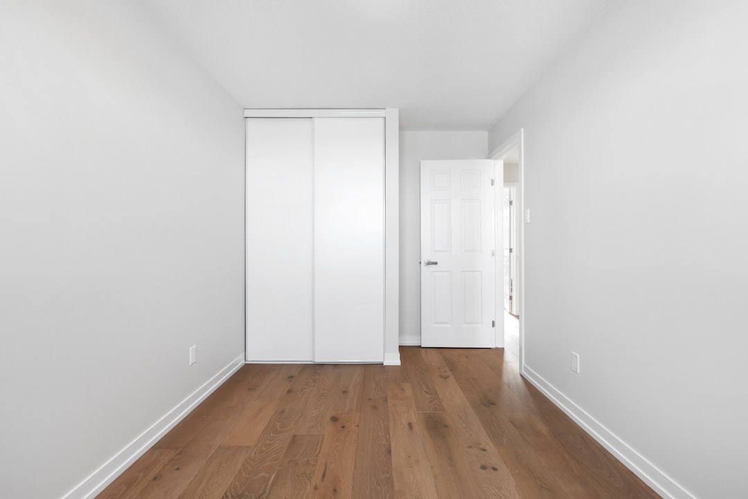 Drywalling vs Traditional Plaster: Which Is Right for Your Project? an-empty-room-with-a-white-door-and-wooden-floor-uxqhjrrvfok